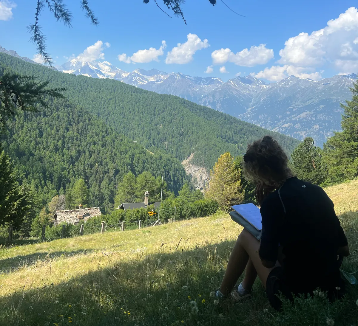 A participant writing in her notebook on the trail