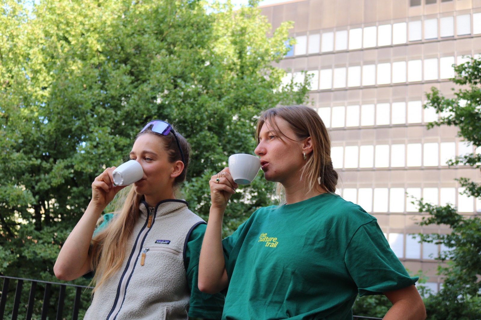 Josien Verkleij and a colleague drinking coffee in The Culture Trail shirts